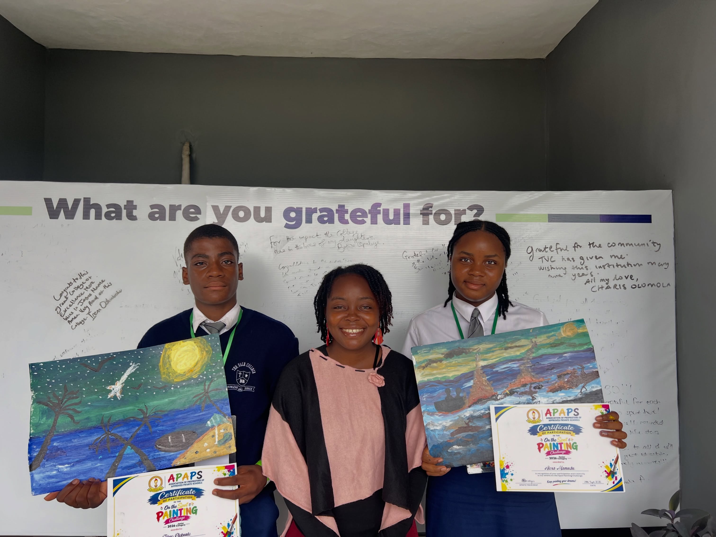Vale College students and a teacher displaying art awards